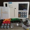 Technocare Medisystems TM-6E Digital 6-Channel ECG Machine complete with its user manual, power cord, limb clamps, chest suction electrodes, thermal paper, and patient lead cables