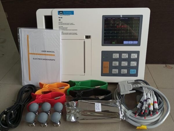 Technocare Medisystems TM-6E Digital 6-Channel ECG Machine complete with its user manual, power cord, limb clamps, chest suction electrodes, thermal paper, and patient lead cables